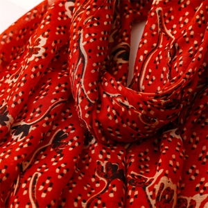 Detailed view of red ethnic floral print scarf showing soft cotton linen fabric texture