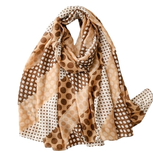 Elegant polka dot print scarf with diagonal patchwork design in warm brown tones