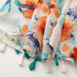 Detail of floral oil painting pattern scarf with dual-tone fringe tassels and linen texture