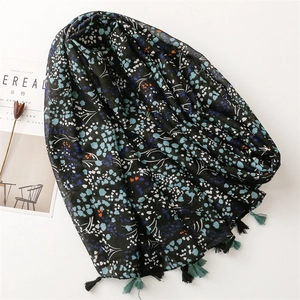 Detail shot of navy floral cotton scarf with tassels and artistic lifestyle props