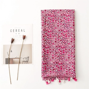 Floral cotton linen scarf in rose red with tassels, ideal for sun protection and beach wear