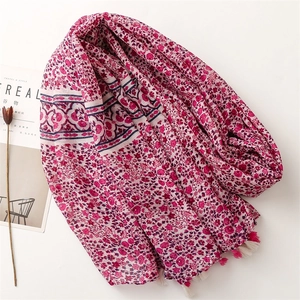 Floral print scarf in rose red with small tassel edges on a minimalist white background
