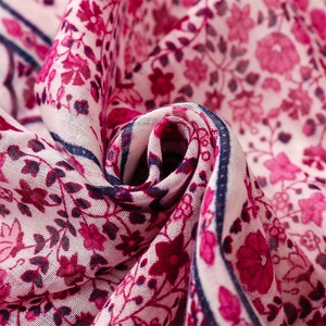 Close-up of lightweight floral fabric with rose print and breathable cotton-linen texture