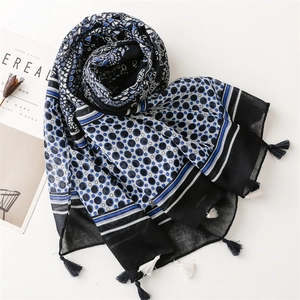 Detail of dark blue paisley scarf with geometric dots and bicolor fringe tassels