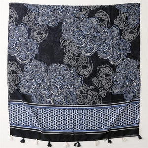 Navy blue paisley beach shawl with white floral patterns and decorative fringe tassels