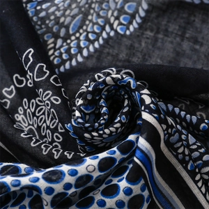 Detailed macro view of the soft textile texture with navy paisley and striped patterns