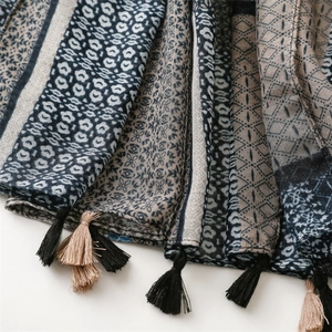 Close-up of geometric print and handcrafted tassels on a bohemian linen-feel scarf