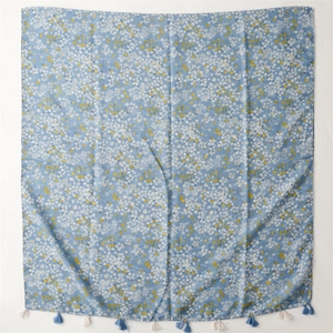 Blue floral scarf with white flowers and tassel trim for sun protection and beach wear
