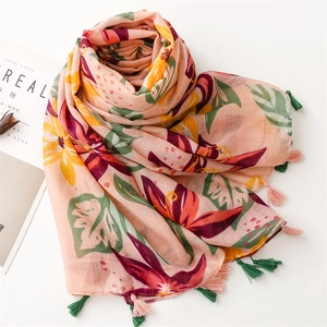 Detail view of tropical floral print scarf with soft fringe edges and linen texture
