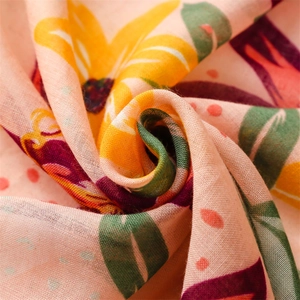 Detailed macro view of tropical floral cotton linen fabric with soft draped texture