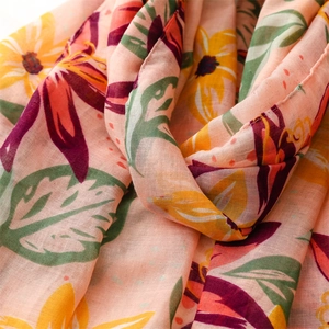 Detailed view of tropical floral print on a pink lightweight cotton linen beach shawl