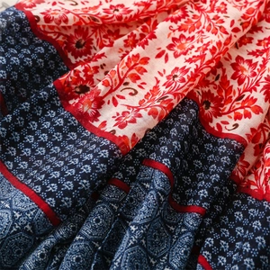 Macro shot of ethnic floral print on light cotton linen scarf with rich fabric texture