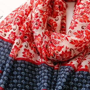 Detail of bohemian floral cotton-linen scarf showing fabric texture and ethnic pattern