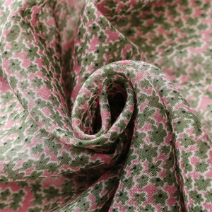 Close-up of soft floral pattern textile showing fine weave texture and tassels