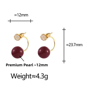 Close-up of 12mm deep red pearl earrings with gold metal and sparkling zircon stones