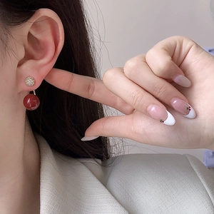 Elegant gold earrings with micro-set zircons and deep red round pearl pendants