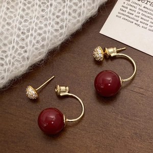 Detailed close-up of retro gold-plated pearl earrings with micro-set zircon accents