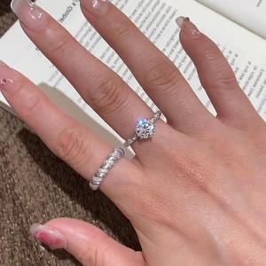 Close-up of sparkling cubic zirconia ring with twisted band on a model's hand