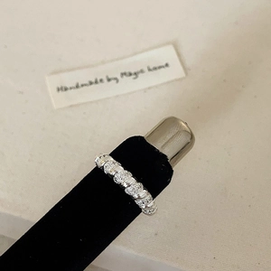 Detailed view of silver ring with segmented vertical texture and glitter sand finish