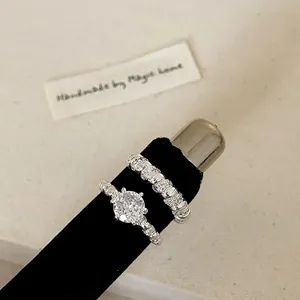 Vintage silver brushed adjustable ring set with large zircon and micro-paved band on stand