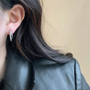 Elegant silver layered zircon earrings with minimalist double hoop design on female model