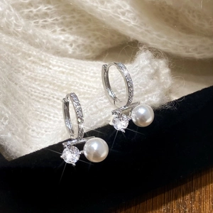 Elegant silver pearl earrings with zircon hoops shown on a black velvet box background
