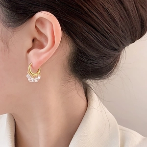 Chic gold hoop earrings with clear crystal bead fringe drops shown on female model