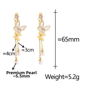 Detailed view of long butterfly tassel earrings with lustrous pearls and metal chains