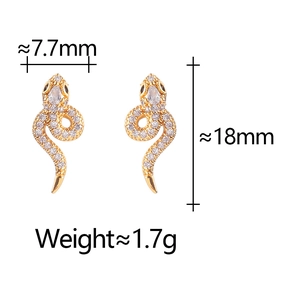 Detailed view of gold snake earrings with pavé crystals and drop-shaped stone accents