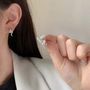 Sparkling silver snake stud earrings with pavé cubic zirconia for a trendy look