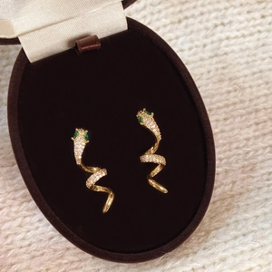 Exquisite gold snake spiral earrings with white zircon pavé and green gemstone eyes