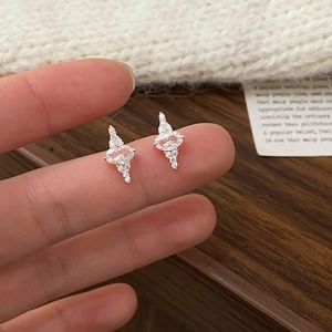 Detailed close-up of radiant silver stud earrings with sparkling oval zircon stones