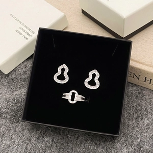 Elegant silver gourd jewelry set with earrings and open ring in a black velvet box