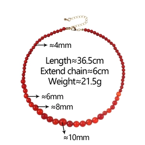 Detail of red agate beaded necklace with gradient size beads and gold lobster clasp