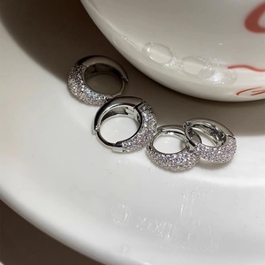 Detail of silver hoop earrings with micro-pave cubic zirconia in two different sizes