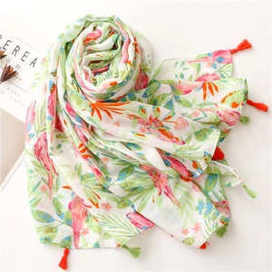 Floral bird print cotton linen scarf with vibrant tassels shown in a spiral layout