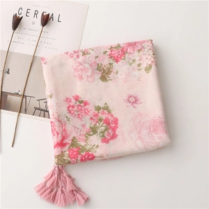 Detail of pink floral cotton linen scarf with elegant fringe trim and rose pattern