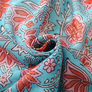 Macro shot of light blue cotton linen fabric with sweet pink water lily floral pattern