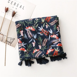 Detail of navy cotton linen scarf with red butterfly flowers and fringe tassels
