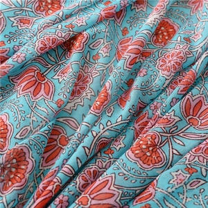 Detailed macro view of water lily print on lightweight sky blue linen blend fabric scarf