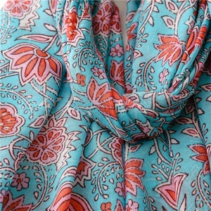 Close-up of sky blue cotton-linen scarf with bohemian floral print and soft texture