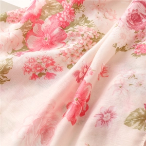 Close-up of elegant pink floral cotton linen scarf with soft digital print texture