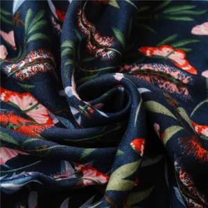 Macro detail of navy blue cotton linen fabric with floral patterns and twill texture