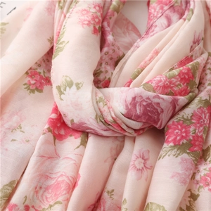 Close-up of elegant pale pink floral scarf showing soft cotton linen texture and detail