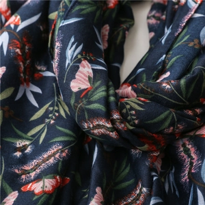 Macro shot of navy linen scarf showing butterfly prints and woven texture detail