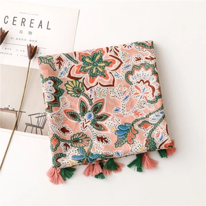 Detail of floral bohemian scarf with colorful tassels and ethnic pattern print