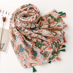 Detailed view of bohemian floral paisley scarf with colorful tassels and soft fringe edges