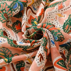 Close-up of bohemian floral paisley shawl fabric with soft weave texture and tassels