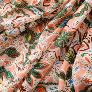 Close-up of bohemian floral paisley print on soft, breathable sun protection scarf fabric