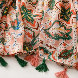 Close-up of Bohemian floral scarf showing fabric texture and colorful fringe tassels